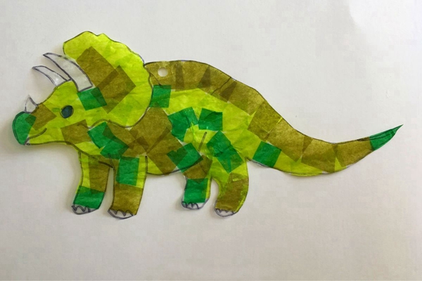 Handmade dinosaur suncatcher craft using tissue paper