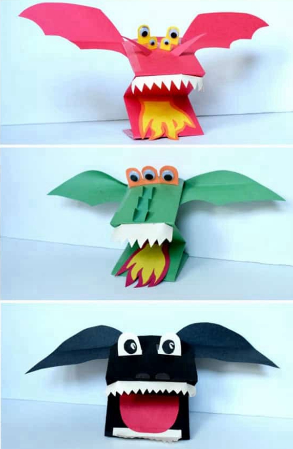 Children playing with homemade paper dragon puppets