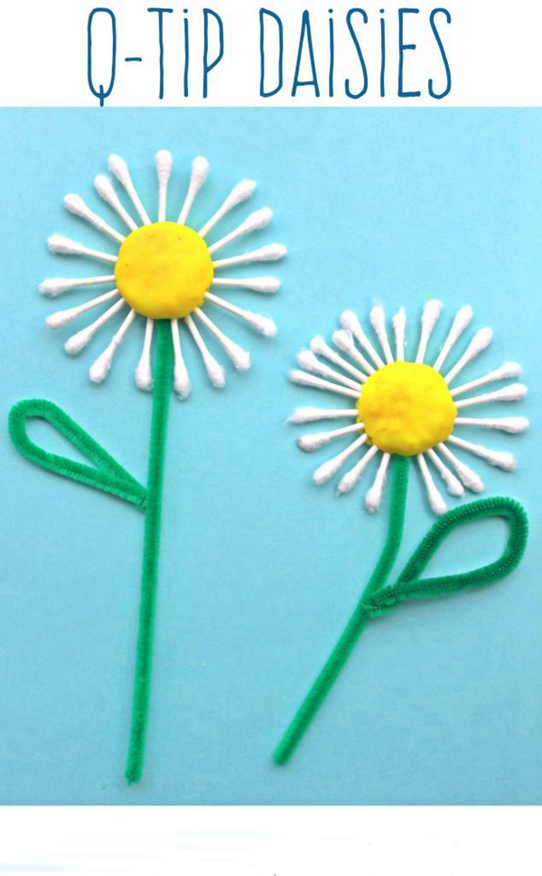 Q-tip daisies with yellow play dough centers and green pipe cleaner stems, a creative and skill-enhancing craft for kids.