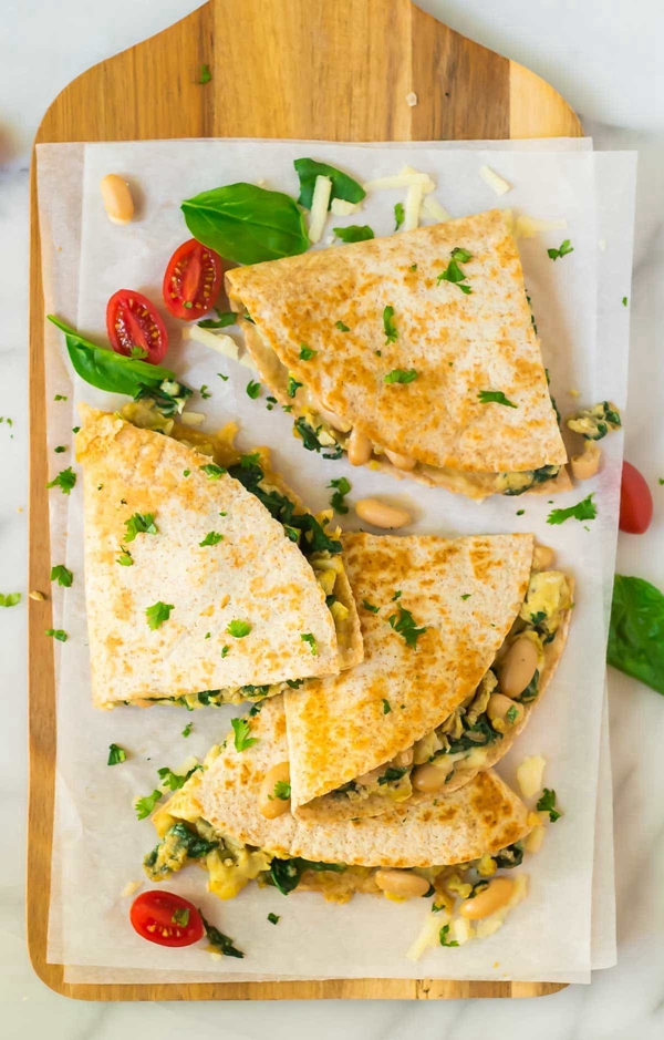 A nutritious and delicious Breakfast Quesadilla, filled with eggs, spinach, white beans, and cheese, wrapped in a whole wheat tortilla, perfect for a quick and healthy start to the day.