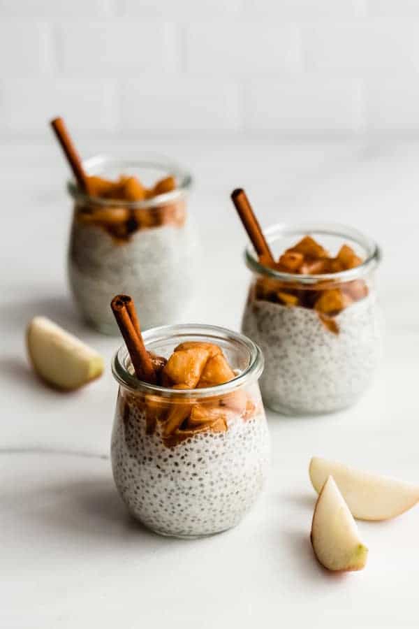 A jar of Cinnamon Apple Pie Chia Pudding topped with stewed maple cinnamon apples.