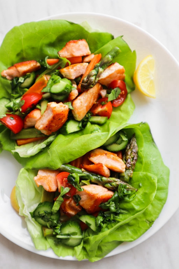 Healthy and flavorful Clean Eating Salmon Lettuce Wraps with fresh vegetables and herby sunflower seed sauce.