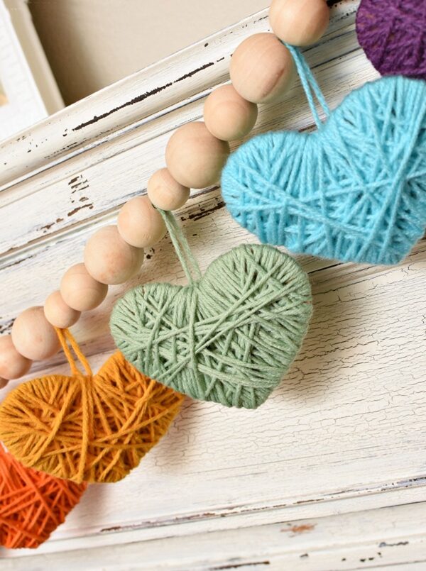 Multicolored yarn heart garland, perfect for Valentine's Day decoration.