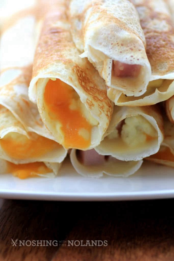 Gourmet Egg, Ham, and Cheese Stuffed Crepes, showcasing a delicious and visually appealing breakfast or brunch option, combining the richness of cheese, the savoriness of ham, and the fluffiness of scrambled eggs.