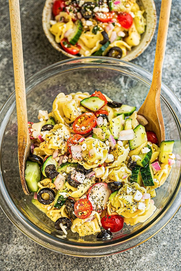 A colorful Greek Tortellini Pasta Salad with Mediterranean ingredients, ideal for a summer gathering.