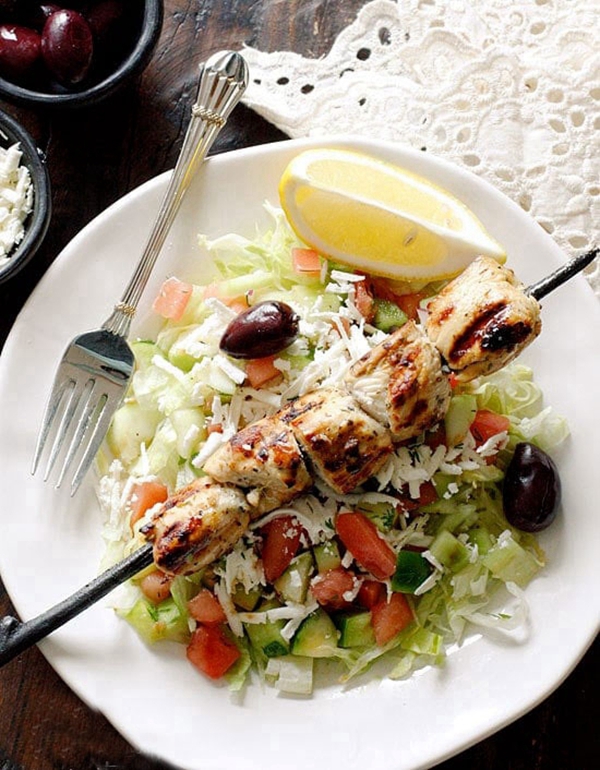 A colorful and appetizing Mediterranean Chicken Kebab Salad, highlighting the juicy grilled chicken and fresh salad, inspired by Skinnytaste's recipe.
