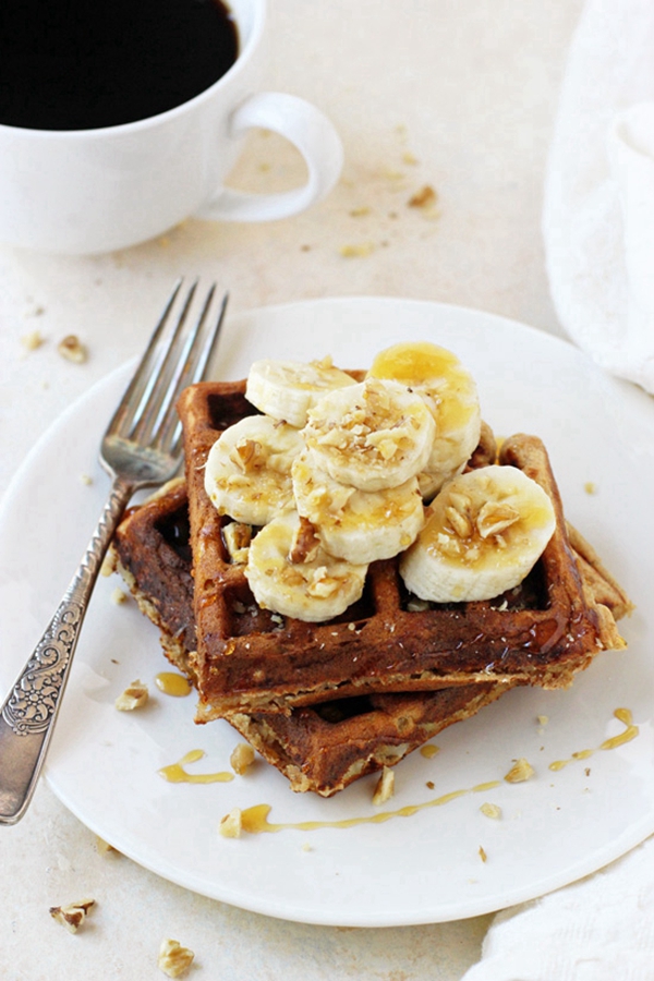 Light and fluffy banana walnut waffles drizzled with honey, ideal for a nutritious breakfast.