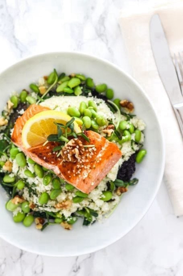 A nutritious Mega Omega Salmon Bowl with salmon, cauliflower rice, edamame, and hemp seeds in a miso ginger dressing.