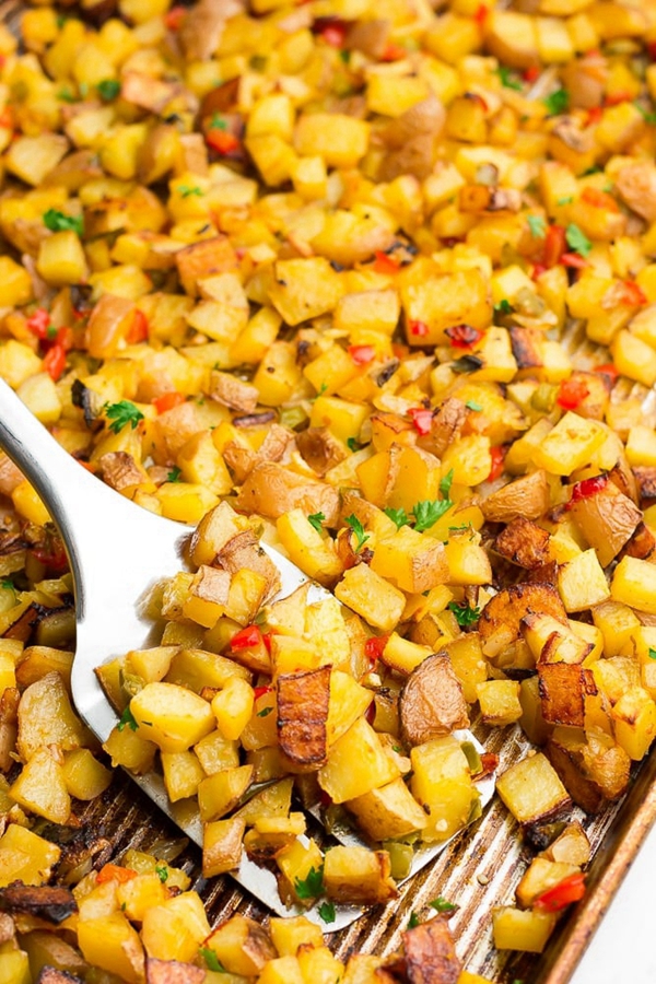 A plate of Oven Roasted Breakfast Potatoes, golden brown and crispy, seasoned with smoked paprika and mixed with onions and bell peppers, ready to complement any breakfast or brunch.