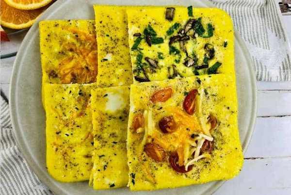 A sheet pan filled with fluffy scrambled eggs, ready to be transformed into convenient and delicious breakfast sandwiches.