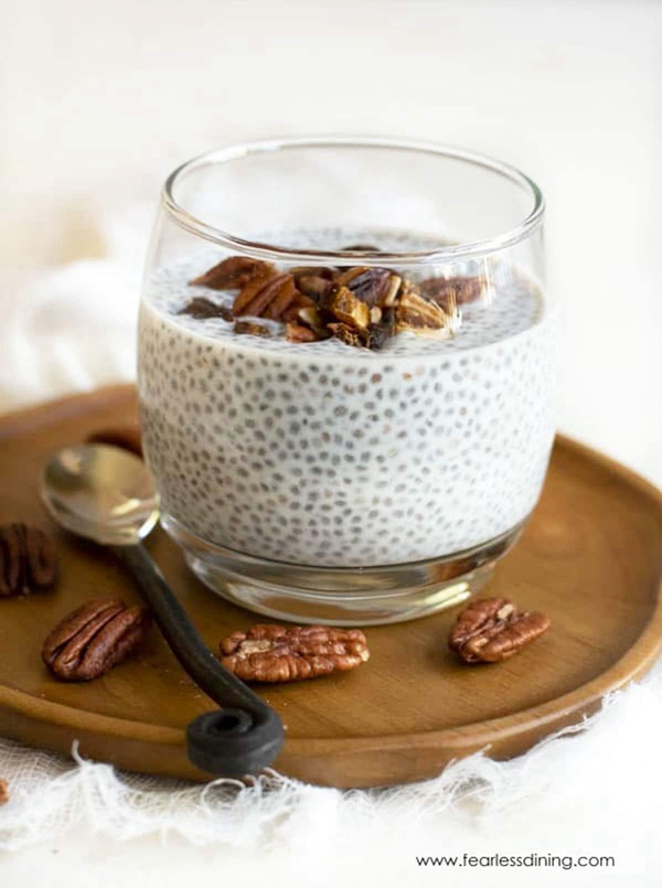Close-up view of Vanilla Chia Pudding topped with dates and pecans.
