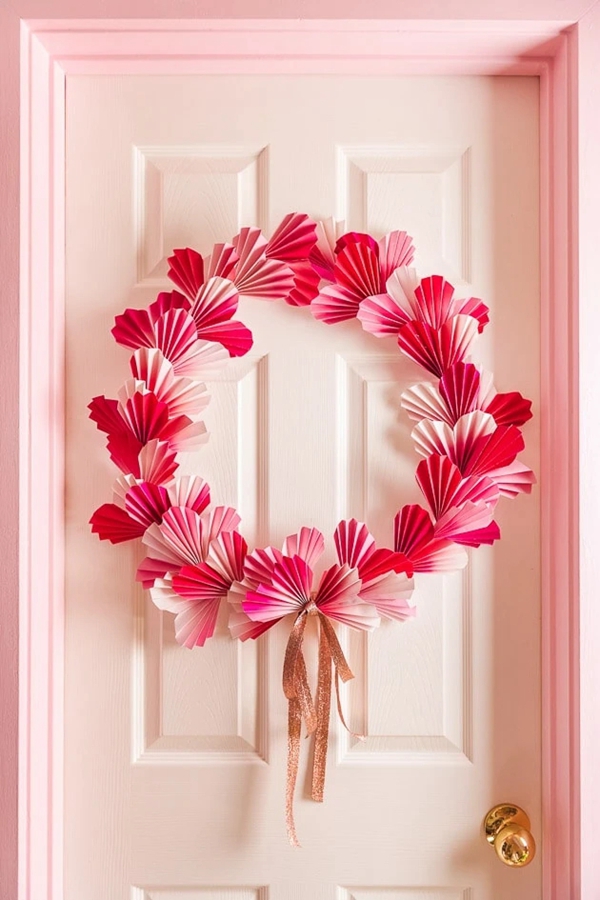 A colorful DIY paper heart wreath, perfect for Valentine's Day door decor.